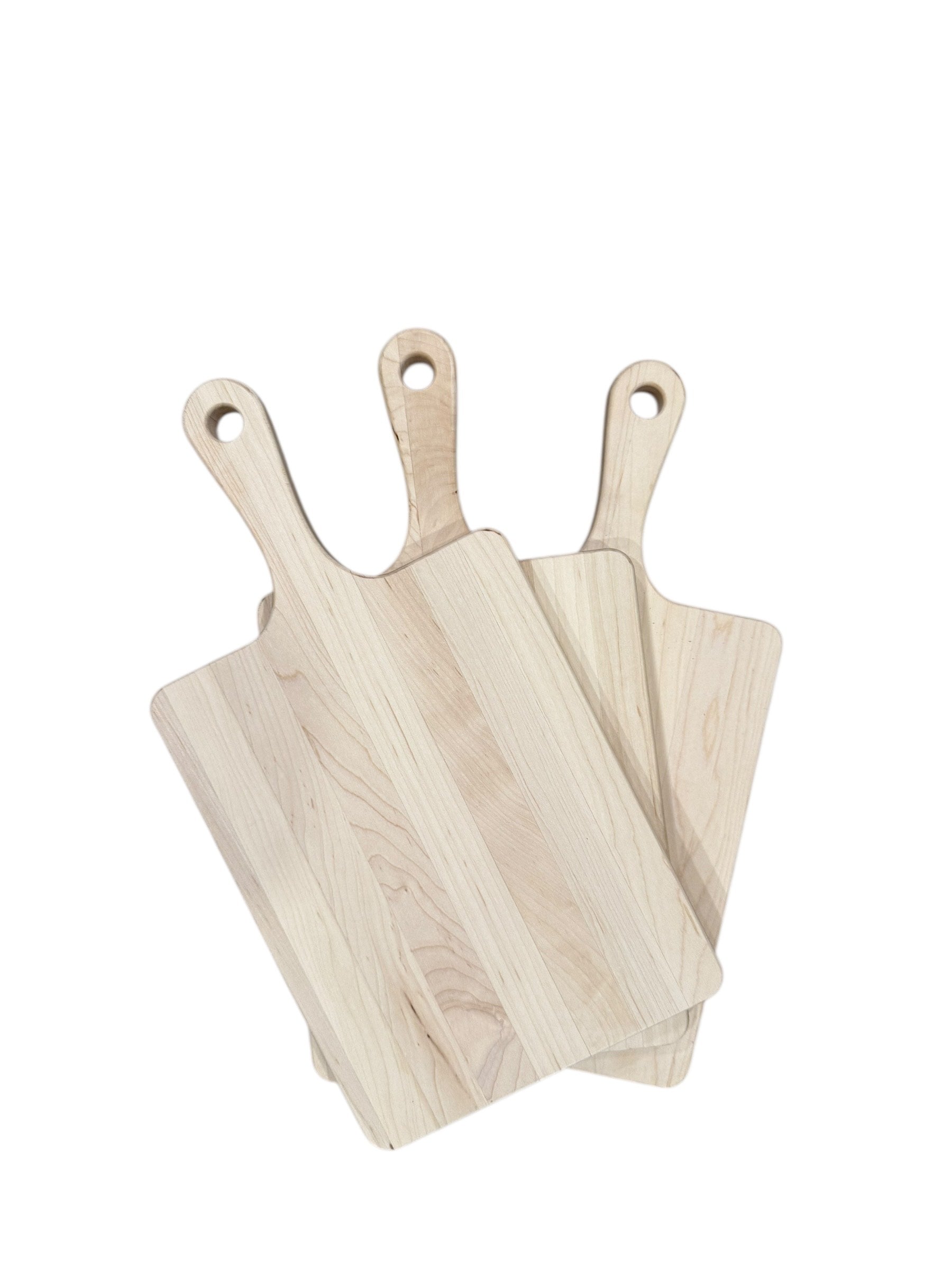 Three wooden cutting boards with handles on a white background